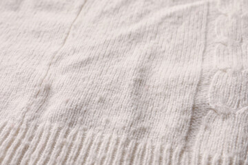 Knitted cloth with lint as background, closeup. Before using of fabric shaver