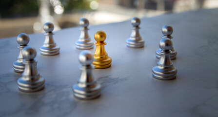 golden chess among group of silver chess pieces On the table, the concept of distinction, the distinction of a person
