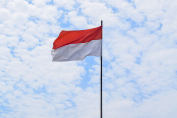 Fototapeta na wymiar Indonesian Flag, Red and White, waving in the wind with blue sky background