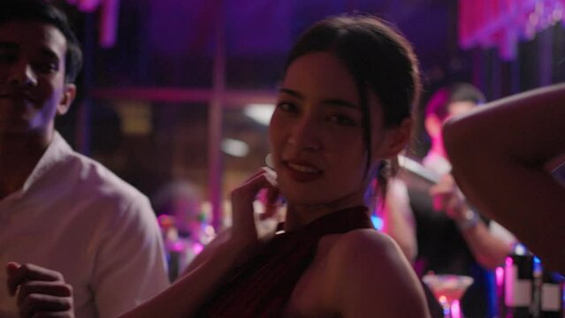 Asian beautiful women having fun, dancing with music in bar restaurant.