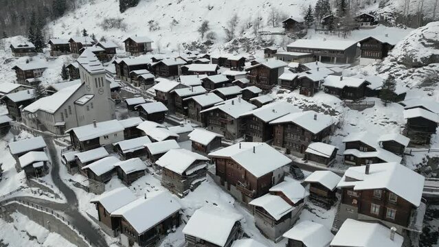 A small village in the mountains in winter. Old houses and a church. It is Blatten in L&ouml;tschental in Switzerland