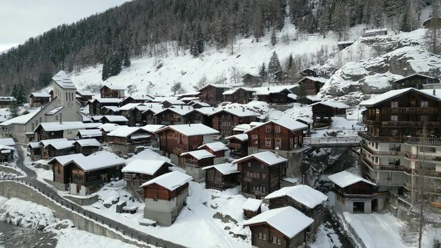 An old Swiss mountain village in winter. Blatten in the L&ouml;tschental valley in Switzerland. The church is in the middle of the village. Everything is covered with snow.