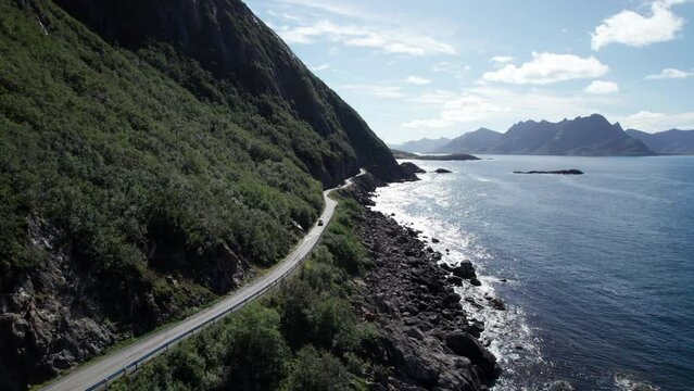 Cars driving on a famous Norwegian costal road during summer in Northern Norway, Aerial forwarding shot