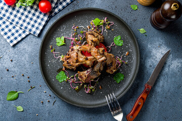 Rack of lamb on black plate top view