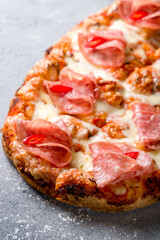 Pepperoni pizza on Roman dough pinsa macro close up vertical