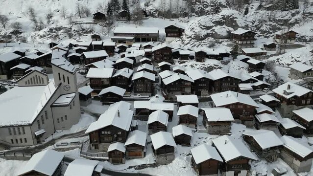 Small old Swiss mountain village in winter. Many old houses and a church. It is Blatten in L&ouml;tschental in the canton of Valais