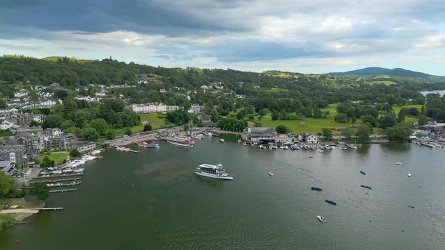 Cinematic aerial view of Bowness-on-Windermere. Showing the small lakeland town and the Lake. sall boats, cruse, small ships. Lake District National Park, Cumbria, UK