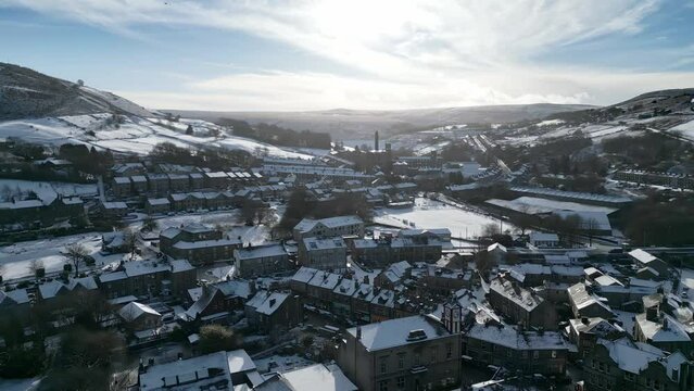 Winter Cinematic Cityscape Townscape with snow covered roof tops 4K Marsden Village West Yorkshire, Endland.