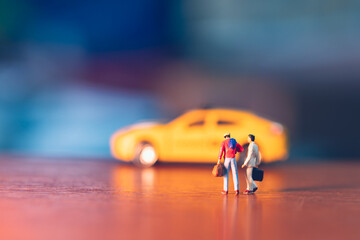 Miniature people, businessman waiting taxi using as business concept