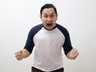 Young Asian man shouting loud because of anger. Concept of rage aggression mad frustration