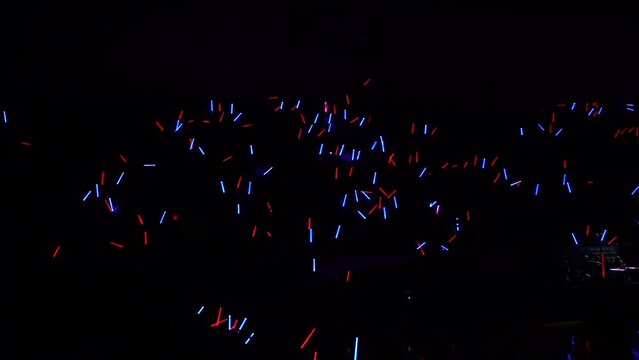 wide shot of crowd with light sabers blue and red