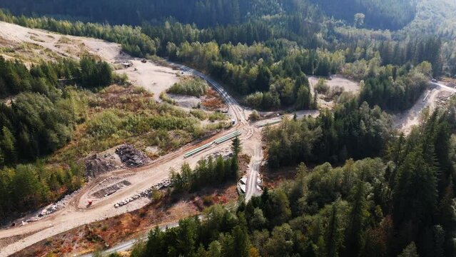 Construction of the TMX oil and gas pipeline in British Columbia Canada. Building an oil pipeline near a river.