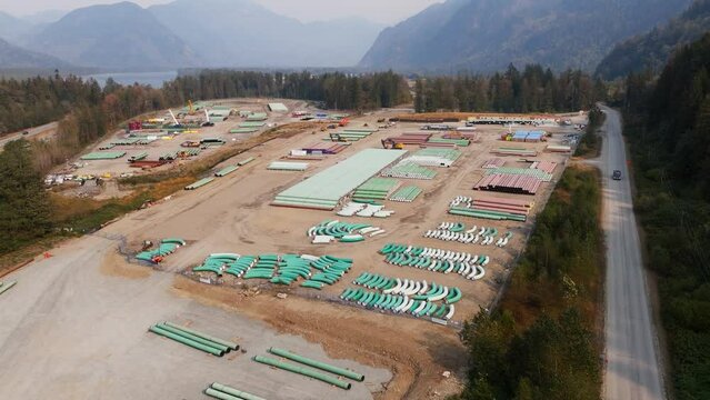 Oil and gas pipeline building. Materials to construct the TMX oil pipeline in BC. The fossil fuel industry's pipe of oil from the Alberta Oil Sands to export crude petroleum products.