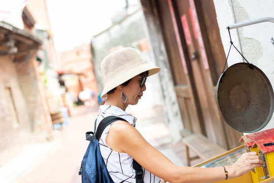 Woman Playing Pinball In The Old Street At Lukang