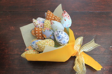 A bouquet of colorful tulips from a patchwork on the table
