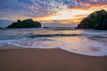 The white sea wave that washes ashore on the brown sand beach and the sky in the morning of the day is a tourist attraction of Bang Saphan District. Prachuap Khiri Khan Province.