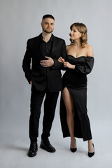 Young woman and young men in a romantic photo shoot, their love story. A romantic dinner. Honeymoon, Valentine's Day.