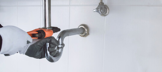 plumber at work in a bathroom, plumbing repair service , fix water plumbing leaks, replace the...