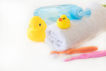 toothbrush of baby with liquid soap, terry cloth health care of baby arrangement flat lay style on background white 