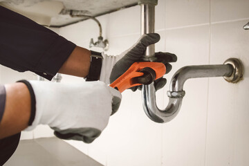 plumber at work in a bathroom, plumbing repair service , fix water plumbing leaks, replace the...