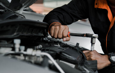 Mechanic fixing a car at home. Repair and service.