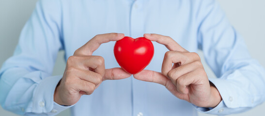 man hand holding red heart shape. love, donor, world heart day, world health day and Insurance concepts