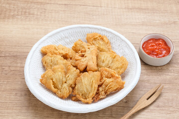 Crispy Fried Oyster Mushroom or Jamur Krispi served with chilli sauce, Indonesian snack
