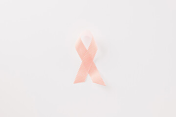 Close up pink awareness ribbon of International World Cancer Day campaign isolated on white background with copy space, concept of medical and health care support, 4 February