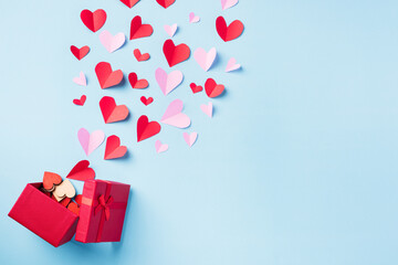 Valentines' day background. Red gift box postcard and paper flying elements hearts cut greeting...
