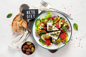 Greek village salad horiatiki with feta cheese, olives, cherry tomato, cucumber and red onion, vegeterian mediterranean food, low calories dieting meal.