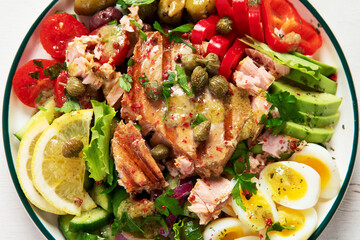 Tuna salad with lettuce, eggs and tomatoes.