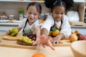 Fototapeta premium The child is playing fruits. children lying on toy kitchen cooking. Kids Educational, creative games.