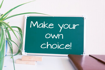 Text Make your own choice written on the green chalkboard