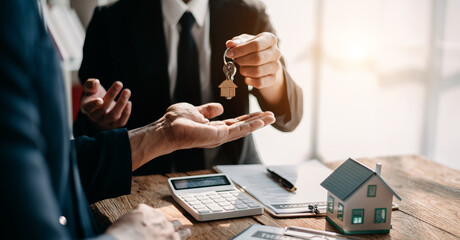 Fototapeta premium Signed the house buy a contract with the house sales agents. Buy or sell home concept. Happy in marketing signing contract of house .