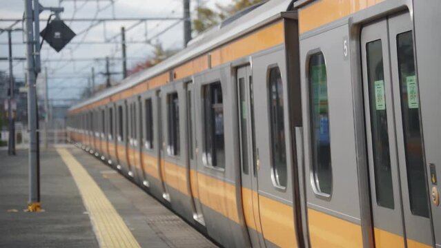 A Japanese train arriving at a station platform.