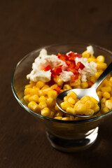 Esquites or Trolley with corn, cheese, mayonnaise and chili. Mexican street food. Close-up