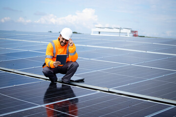 Solar energy worker or engineer with his laptop computer checking installation and productivity of new solar power plant. © littlewolf1989