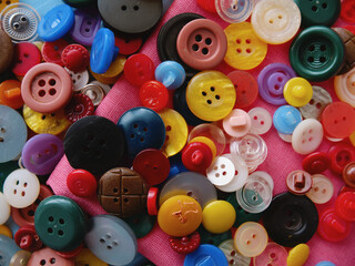 Background of colored buttons for clothes of different sizes