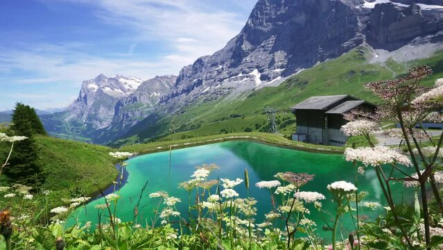 Scenic mountain lake near Kleine Scheidegg. Mountain Eiger and Jungfrau mountain, Swiss Alps in summer. 