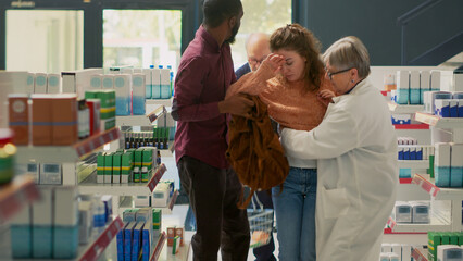 Young adult with spinning sensation and dizziness losing balance in pharmacy shop, almost fainting...