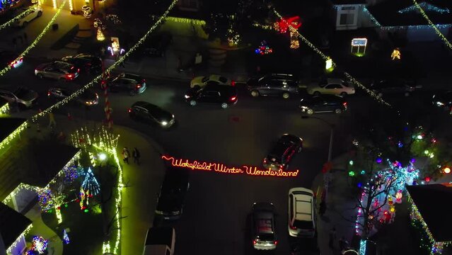 Christmas Winter Wonderland over Valencia Neighborhood at night with traffic of cars, aerial rising view