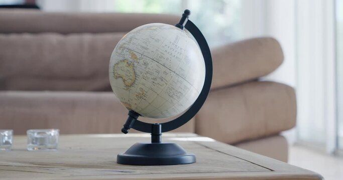 Rotation around a terrestrial globe placed on a living room table