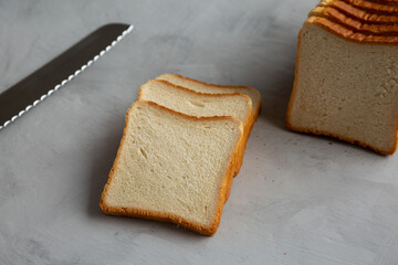 Sliced Whole Wheat White Bread on a gray background, side view.
