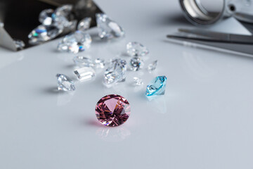 Coloured diamonds of different sizes at the workplace of a diamond expert sorting. High quality photo