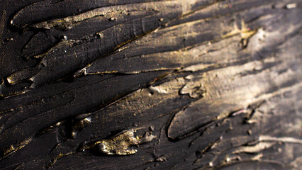 Photo-relief dark rough stripes with golden shine