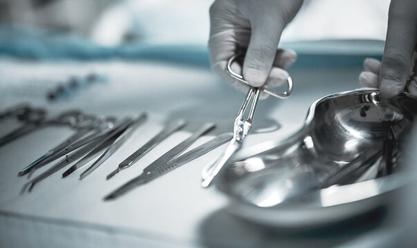Healthcare, surgeon and medical instruments for surgery in a ER or operating room in the hospital. Emergency, steel appliances and nurse giving tools to a doctor for a operation in surgical theatre.