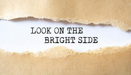 'Look on the bright side' written under torn paper.