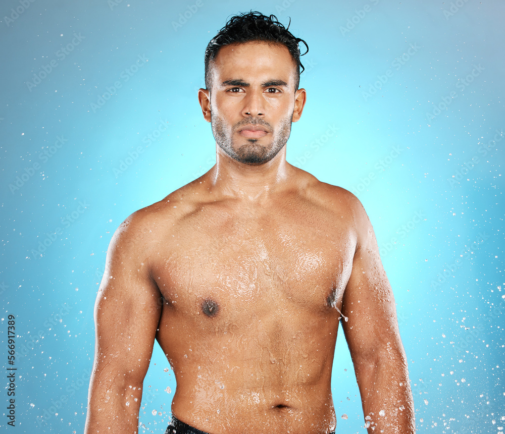 Poster Water splash, portrait and man in studio for skincare, wellness and grooming on blue background. Cleaning, beauty and moisture by Mexican model relax with luxury, routine and body care while isolated