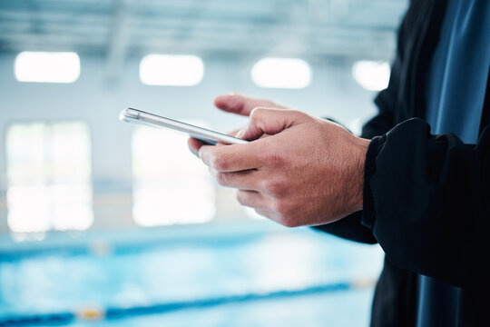 Hands, man and phone for texting by swimming pool for communication, social media or contact on web. Aquatic sports athlete, smartphone and typing on screen with mobile app, website and internet chat