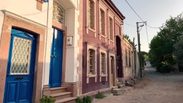 Footage of old, historical stone houses in Cunda island of Ayvalik district of Turkey. It is a sunny summer day.
